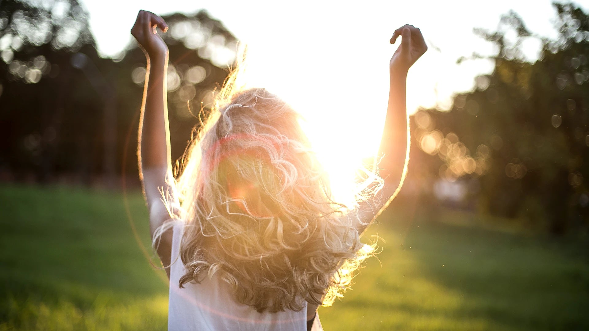Woman dancing outside in the sun